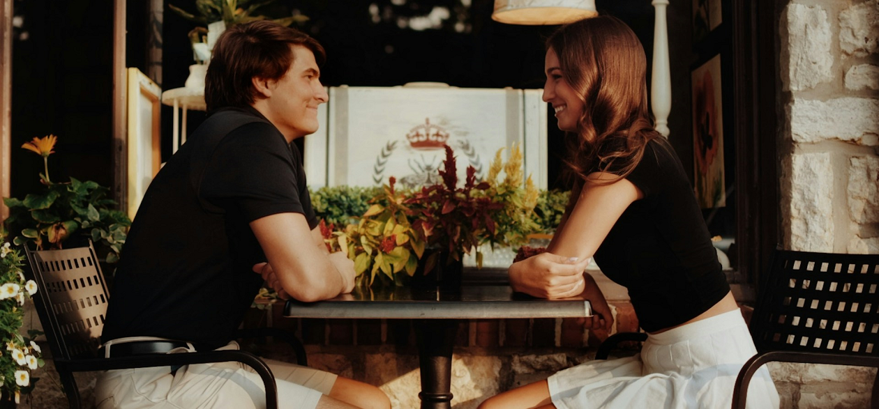 A couple lovingly staring at each other's eyes.