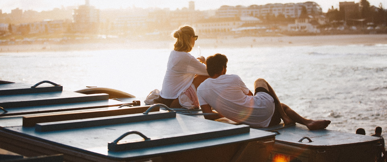 Couple lounging on a dock.